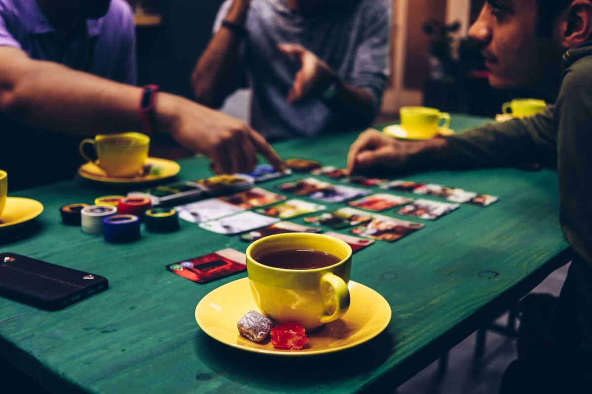 A group playing a card game together at a table