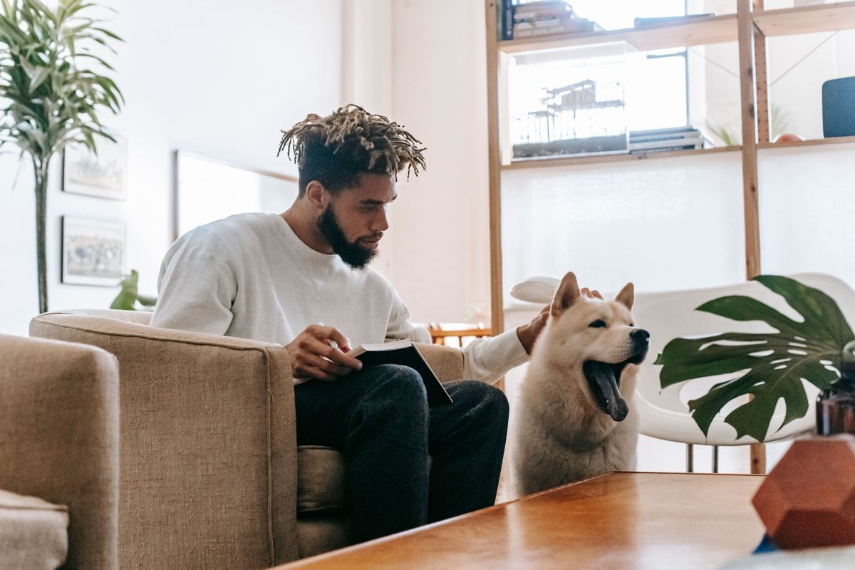 Resident reading with his dog at home
